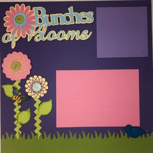 May include: Purple scrapbook page with the words "Bundles of Blooms" in yellow and blue letters. The page has a pink and green flower design with a butterfly and a blue bird. There are two blank spaces for photos.