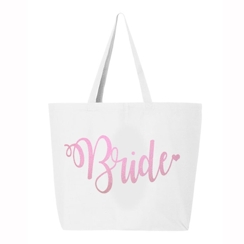 May include: White canvas tote bag with a pink glitter design that says "Bride" with a small heart.