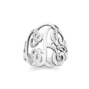 May include: A silver ring with a large, ornate, monogrammed letter 'F' design.