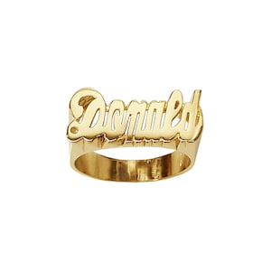 May include: Gold ring with the name "Donald" spelled out in a cursive font.