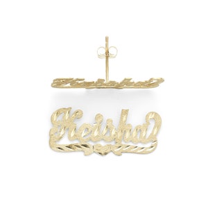 May include: Gold-tone earrings with the name "Keisha" spelled out in a cursive font. The earrings have a diamond-shaped pattern.