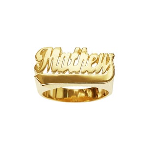May include: A gold ring with the name "Matthew" engraved in a bold, cursive font.