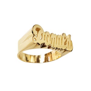 May include: A gold ring with the name "Donald" engraved in a cursive font.
