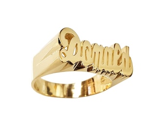 May include: A gold ring with the name "Donald" engraved in a cursive font.