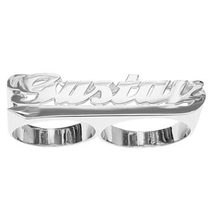 May include: A silver double finger ring with the name "Justin" engraved in a bold, cursive font.