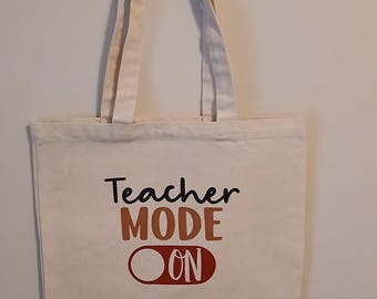 Teacher tote bags. Teacher Mode On. Quote.