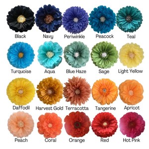 May include: A collection of colorful fabric flowers in various shades, including black, navy, periwinkle, and teal. Each flower has a detailed center and is labeled with its color name, such as "Turquoise," "Apricot," and "Red."