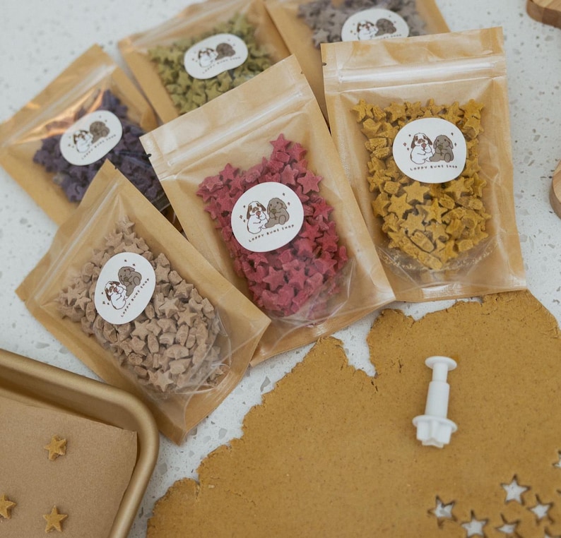 May include: A white ceramic mug with a black handle and the text "But First, Coffee" in a black, handwritten-style font. The mug is on a white surface.