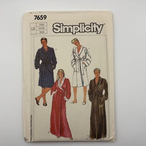 May include: A Simplicity sewing pattern envelope labeled 7659 in size Large. The front features illustrations of four different bathrobes: a blue plaid robe, a white robe, a red robe with white trim, and a long dark brown robe with white trim.