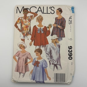 May include: A McCall's 9390 sewing pattern envelope featuring illustrations of various tops. The designs include a floral print shirt, a solid red top with a white collar and striped bow, a plaid tunic, a striped top, and a blue top with a bow.