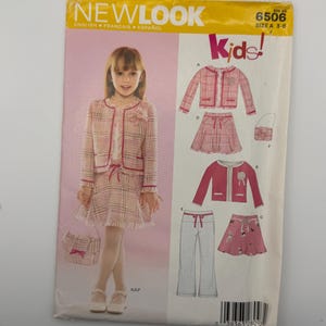 May include: A New Look 6506 sewing pattern envelope for children's clothing, size A 3-8. The front displays a photograph of a child wearing a plaid jacket and skirt set with a matching handbag, alongside illustrations of jacket, skirt, and pant variations.