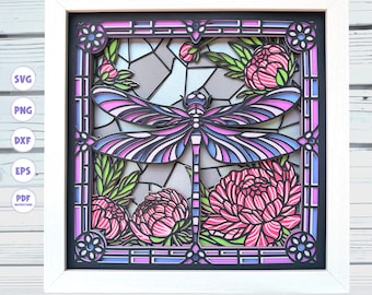 May include: A framed laser cut design featuring a purple and blue dragonfly with pink peonies. The design is in a stained glass style with a black frame.