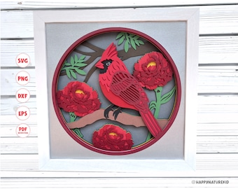 Puede incluir: Un pájaro cardenal rojo posado en una rama con flores rojas. La imagen es un diseño de artesanía en papel en capas, con el pájaro y las flores que parecen salir del fondo.