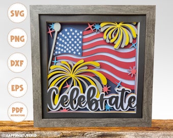 Può includere: Un'artigianato di carta incorniciato con una bandiera americana rossa, bianca e blu, fuochi d'artificio gialli e grigi e la parola "Celebrate" in lettere nere.