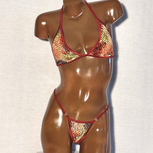 May include: A red and gold sequined bikini with a halter top and a low-rise bottom.