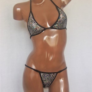 May include: A black sequined bikini top and matching bottom. The top is a halter style with adjustable straps. The bottom is a thong style with a low rise.