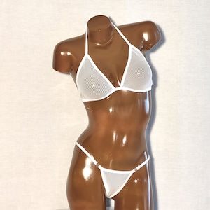 May include: White mesh bikini top and bottom with adjustable straps. The bikini is made of a fine mesh material and has a delicate, feminine look.