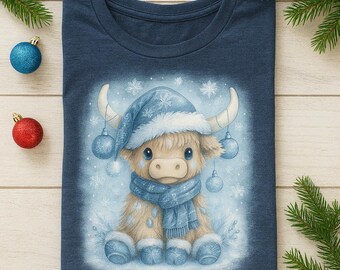 May include: Navy blue t-shirt featuring a whimsical illustration of a Highland cow wearing a blue winter hat, scarf, and boots. The cow is adorned with hanging ornaments and snowflakes, creating a festive winter scene. Christmas-themed apparel.