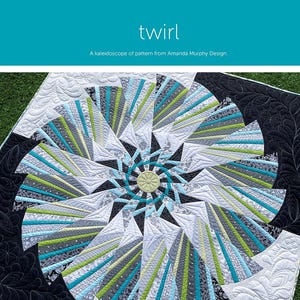 May include: A quilt pattern called "Twirl" by Amanda Murphy Design. The quilt features a swirling design in shades of black, white, green, and blue.