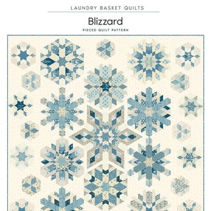 May include: A quilt pattern called "Blizzard" with a pieced design featuring snowflakes in shades of blue and cream on a white background. The quilt measures 63 1/2 inches by 65 inches.