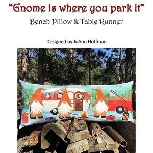 May include: A colorful bench pillow and table runner featuring gnomes camping with a camper van. The pillow is 16 inches by 38 inches and features a raw edge applique design. The text "Gnome is where you park it" is displayed at the top of the image.