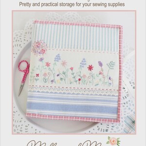 May include: A fabric sewing folder featuring blue and white striped panels, a central white section with colorful floral embroidery, and a red and white checkered border. The text reads Simple Sewing Folder, Pretty and practical storage for your sewing supplies, and Molly and Mama, STUDIO for PRETTY STITCHES.
