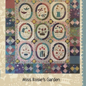May include: A colorful quilt with a patchwork design featuring nine oval-shaped blocks with embroidered images of flowers, birds, and other garden elements. The quilt is titled "Miss Rosie's Garden" and is surrounded by a border of floral and bird motifs. The quilt is made by Hatched and Patched.