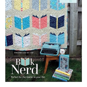 May include: A quilt pattern featuring a book design with the title "Book Nerd" and the text "Finished Size: 54" x 66". The quilt is displayed on a wooden fence with a vintage typewriter and a stack of books.