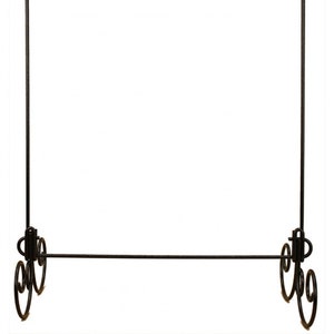 May include: Black metal garment rack with a single horizontal bar and a decorative scrolled base.