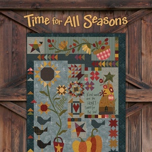 May include: A quilt pattern featuring a variety of autumnal designs, including sunflowers, pumpkins, birds, and stars. The quilt is made in a blue and brown color scheme and has the text "Time for All Seasons" and "Kind words are like HONEY - Sweet for the soul" on it. The quilt is designed by One Sister.