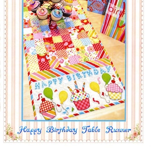 May include: A colorful Happy Birthday table runner with a patchwork design. The runner features cupcakes, balloons, and the words "Happy Birthday." The image also includes cupcakes on a tiered stand and gift bags.