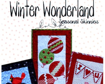 May include: Three quilted wall hangings with a winter wonderland theme. The first features a snowman with a black top hat and a red cardinal. The second features a row of colorful Christmas ornaments. The third features a red envelope with hearts and the text "I love you". The hangings are made by Ribbon Candy Quilt Company.