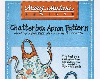 May include: A sewing pattern for a reversible apron, inspired by a vintage apron. The pattern is called "Chatterbox Apron Pattern" and features two different apron designs, one with a floral print and the other with a blue and green print. The pattern is designed to be quick and easy to sew and uses only 2 yards of fabric. The pattern is also reversible, so you can choose to wear either side. The pattern is great for gifts and is one size fits most.