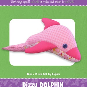 May include: A pink and white fabric dolphin plush toy with a pink polka dot pattern. The toy is 17 inches long and is called "Dizzy Dolphin".