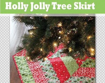 May include: A red and green quilted Christmas tree skirt with a snowflake and tree pattern. The skirt is made of fabric scraps and has a scalloped edge. The skirt is under a Christmas tree with lights.