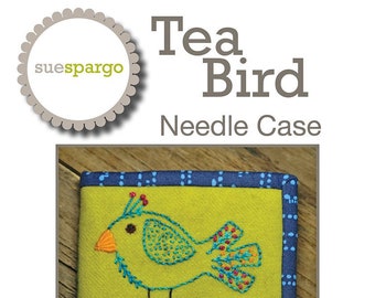 May include: A green felt needle case with a blue border. The case features an embroidered design of a yellow bird perched on a colorful teacup and saucer. The text "Tea Bird Needle Case" and "Size (closed): 4" x 6" is printed below the image.
