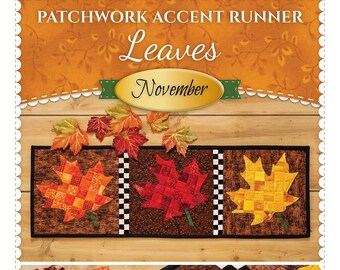 May include: Patchwork Accent Runner "Leaves" by Shabby Fabrics.com. The runner features three fall-colored maple leaves with a checkered border. The leaves are made of patchwork fabric in shades of red, orange, and yellow.