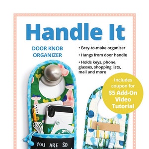 May include: A colorful door knob organizer with pockets for keys, phone, and other items. The organizer has a chalkboard pocket with the text "You are so beautiful to me!" and hangs from a door knob. It includes a coupon for a $5 video tutorial.