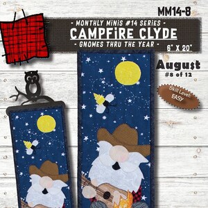 May include: A fabric wall hanging featuring a gnome playing a ukulele by a campfire under a starry night sky. The design includes the text "CAMPFIRE CLYDE" and measures 6" x 20". The skill level is "EASY".