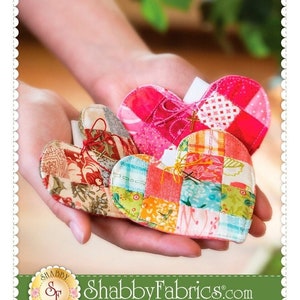 May include: A patchwork heart quilt pattern with the title "Patchwork Heart Pocket Prayer Quilt" and the website "ShabbyFabrics.com". The image shows three patchwork hearts in a person's hands.