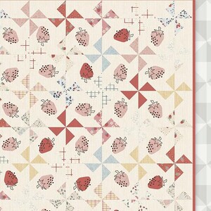 May include: A quilt pattern featuring a white background with red, pink, and blue pinwheels and strawberries. The text "Strawberry Fields by megs & mi" is at the bottom of the quilt pattern.