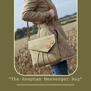 May include: A brown quilted jacket with a brown leather shoulder bag. The bag has a plaid pattern and two large brown buttons. The bag is worn over the shoulder of a person standing in a field of wheat.