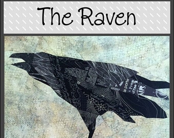 May include: A black raven silhouette perched on a colorful hexagonal quilt with the text "The Raven" and "Saginaw St Quilts" at the top and bottom of the image.