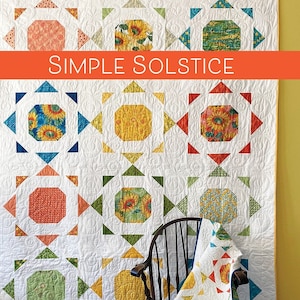 May include: A quilt pattern called "Simple Solstice" featuring a sunflower design in shades of yellow, orange, green, and blue. The pattern is described as "Charm Pack-Friendly (Small) or Layer Cake-Friendly (Large)".