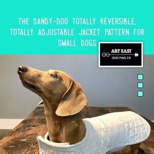 May include: A brown dachshund wearing a light gray quilted dog jacket. The jacket is reversible and adjustable. The text "THE DANDY-DOO TOTALLY REVERSIBLE, TOTALLY ADJUSTABLE JACKET PATTERN FOR SMALL DOGS" is at the top of the image. The text "ART EAST QUILTING CO" is in the upper right corner of the image. The text "QUILT JACKET PATTERN FOR YOUR BEST FRIEND" is at the bottom of the image.