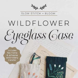 May include: Two eyeglass cases with floral embroidery. One is beige with orange and blue flowers, the other is dark green with white and yellow flowers. The text reads "WILDFLOWER Eyeglass Case" and "SLOW STITCH + BLOOM".