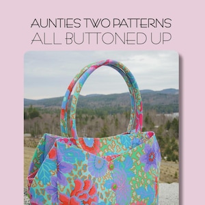 May include: A floral patterned tote bag with a button closure. The bag is made from Kaffe Fassett Fabrics and measures 12 inches tall, 14 inches wide, and 6 inches deep. The bag has a colorful floral design with red, purple, and blue flowers.