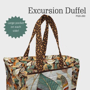 May include: A quilted Excursion Duffel bag with a leaf pattern in shades of green, brown, and beige. The bag has brown handles with a polka dot design. The text "Excursion Duffel" and "Large pocket on each side!" are visible.