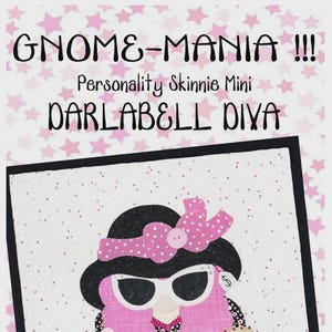 May include: A whimsical quilt featuring a pink-haired gnome wearing sunglasses, a black hat with a pink polka-dot bow, and a black and white patterned dress. The gnome is holding a blue purse with the word "SALE" and a small dog. The text "GNOME-MANIA" is at the top.