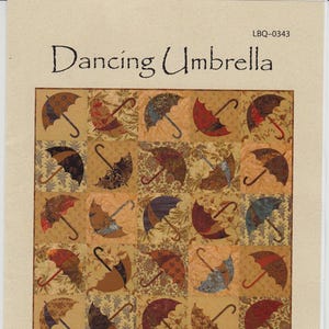 May include: A quilt pattern titled "Dancing Umbrella" featuring a grid of umbrella designs in various colors and patterns. The quilt measures 45" x 54". The text "Laundry Basket Quilts" is also present.